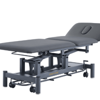 Stealth 3 section electric treatment table in black with surround bar foot switch