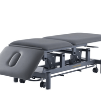 Stealth 3 section electric treatment table in black with surround bar foot switch